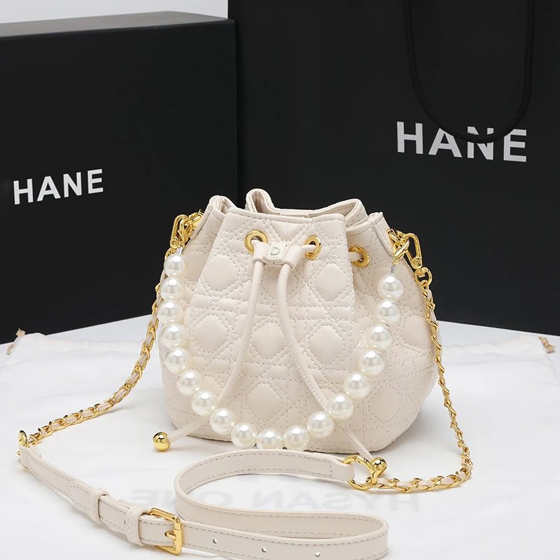 HANE Pearl-Embellished Quilted Bucket Bag Beige Handbags