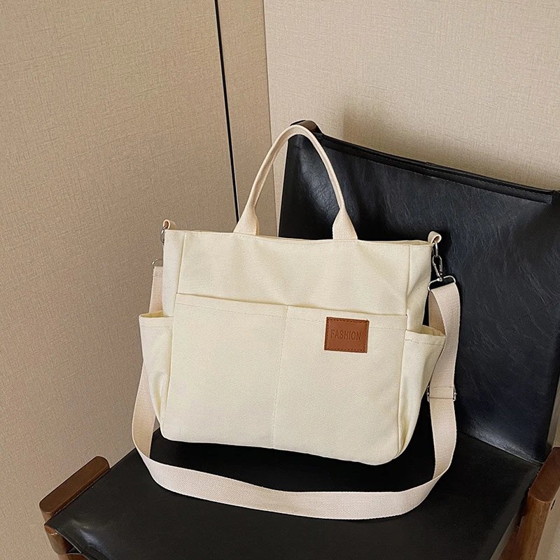 日系轻便多格层手提肩包防水休闲通勤百搭托特包纯色软面帆布包女
