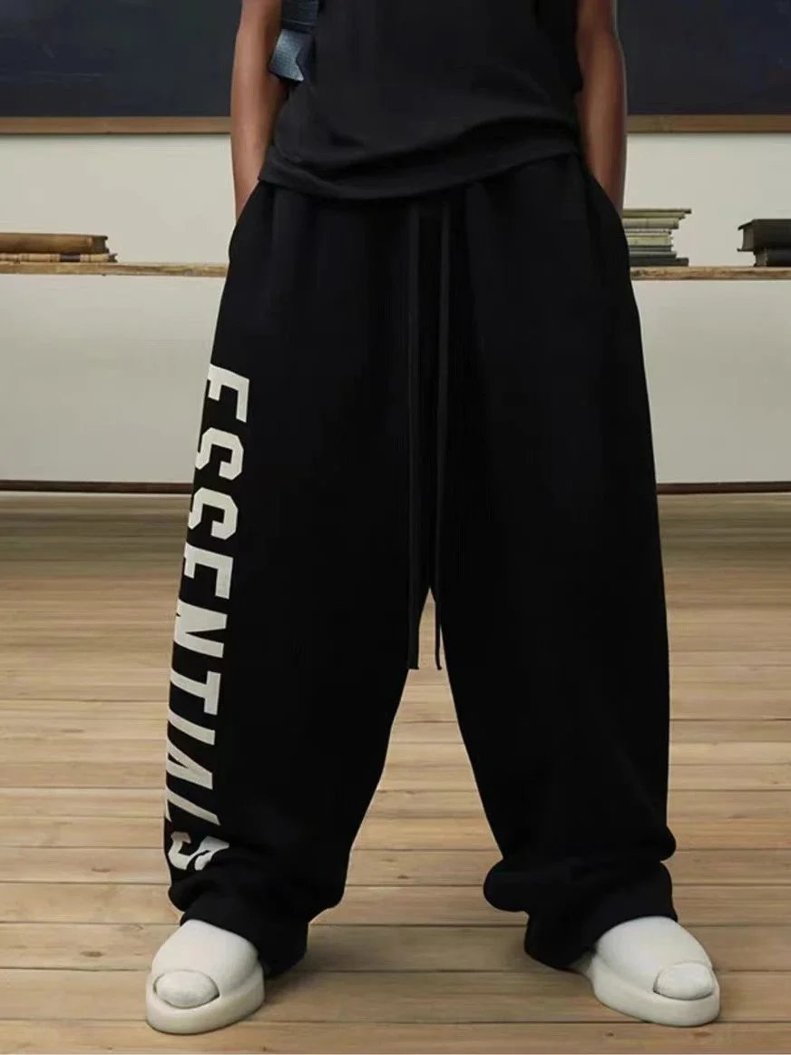 Fear of God Essentials Trousers Wide-Leg Drawstring with Vertical Leg Print — Black