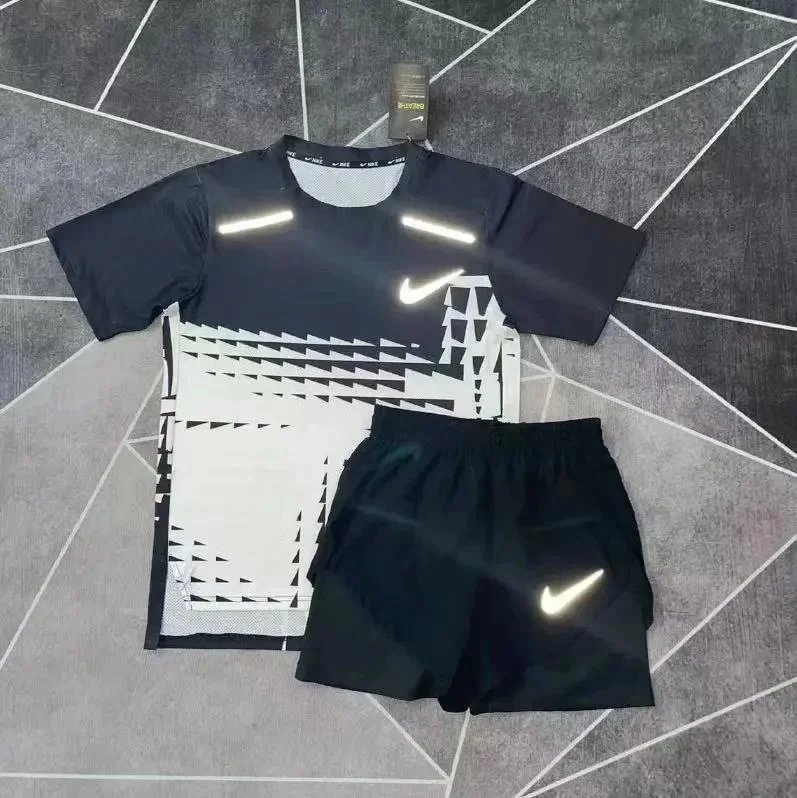 Nike Matching Sets Patterned running top and reflective shorts set — DA black-and-white short-sleeve top with a matching three-quarter-length shorts set