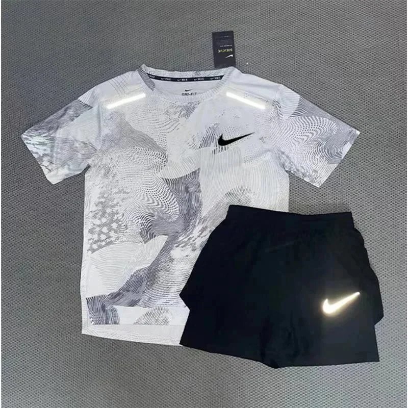 Nike Matching Sets Patterned running top and reflective shorts set — White and gray short-sleeve top with a matching three-quarter-length shorts set