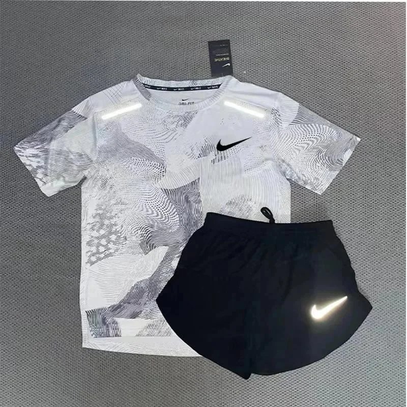 Nike Matching Sets Patterned running top and reflective shorts set — White and gray short-sleeve top and three-quarter-length shorts set