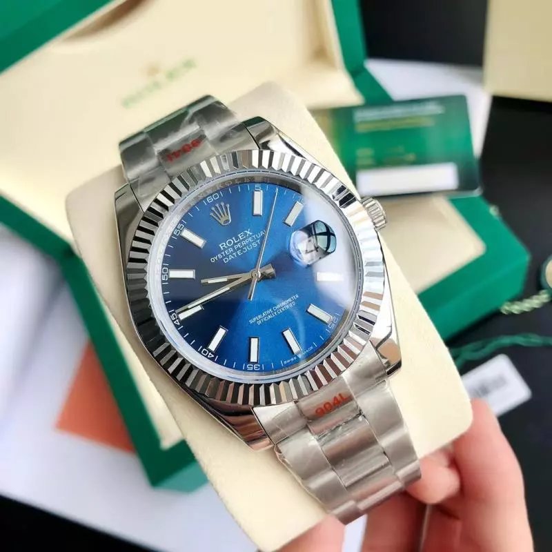 Rolex Watches Datejust fluted-bezel bracelet watch — Silver case with blue dial, three-link bracelet, and mineral‐strengthened glass.
