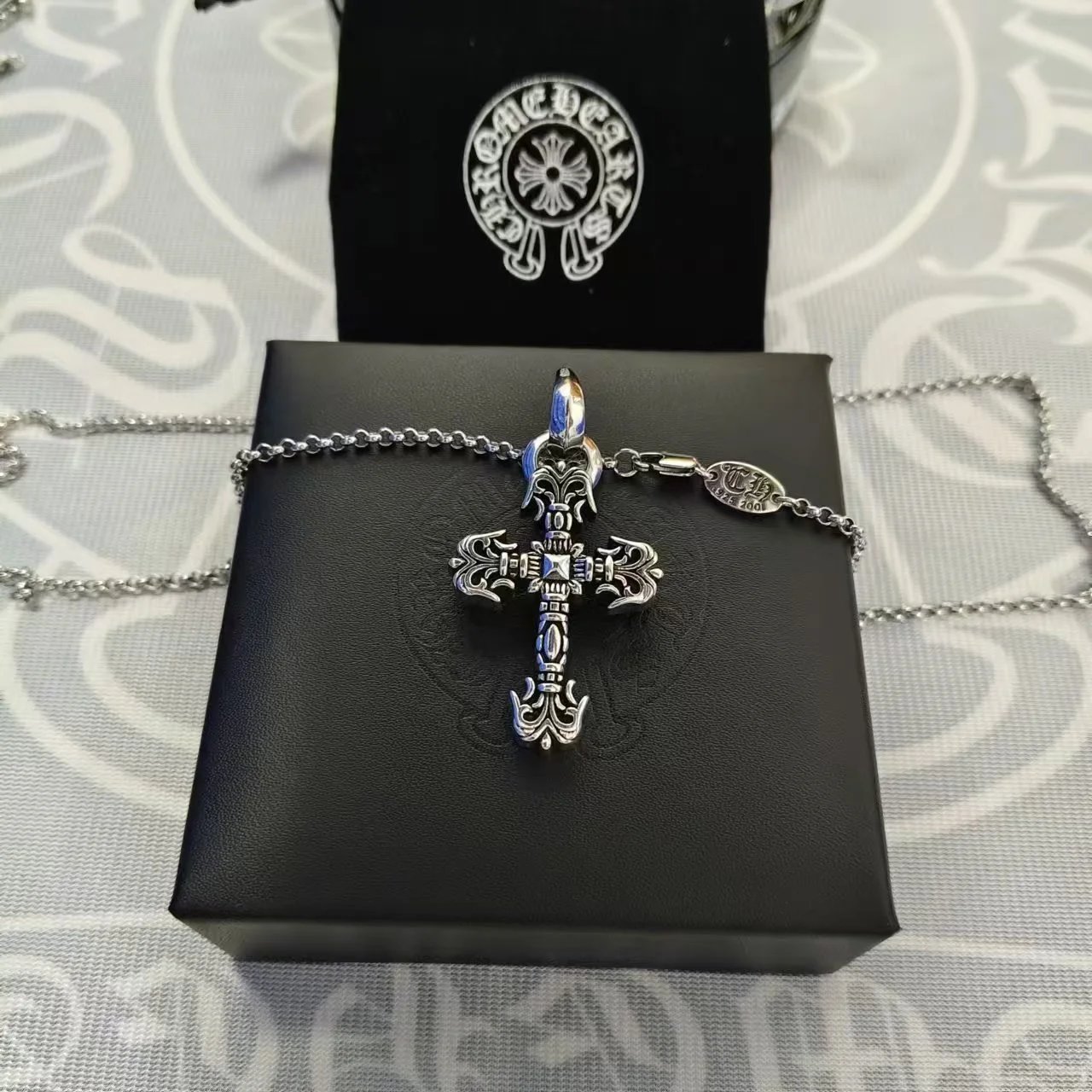 Small flame cross with pearl chain