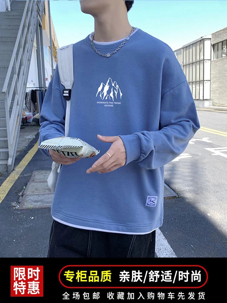 light blue crewneck sweatshirt with white mountain graphic and text, ribbed cuffs and hem, small woven label on lower right