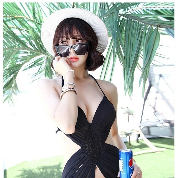 black halter neck one-piece swimsuit with lace panel and side cutouts