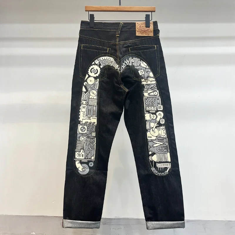 EVISU: Raw Selvedge Straight-Leg Jeans with Mechanical Gear Print and Large "M"