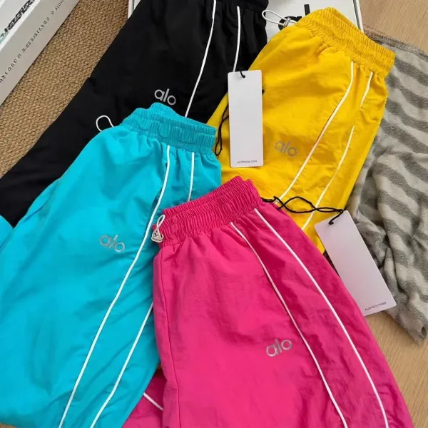 Alo Yoga Track Pants in Black, Turquoise, Pink, and Yellow Sweatpants - 1