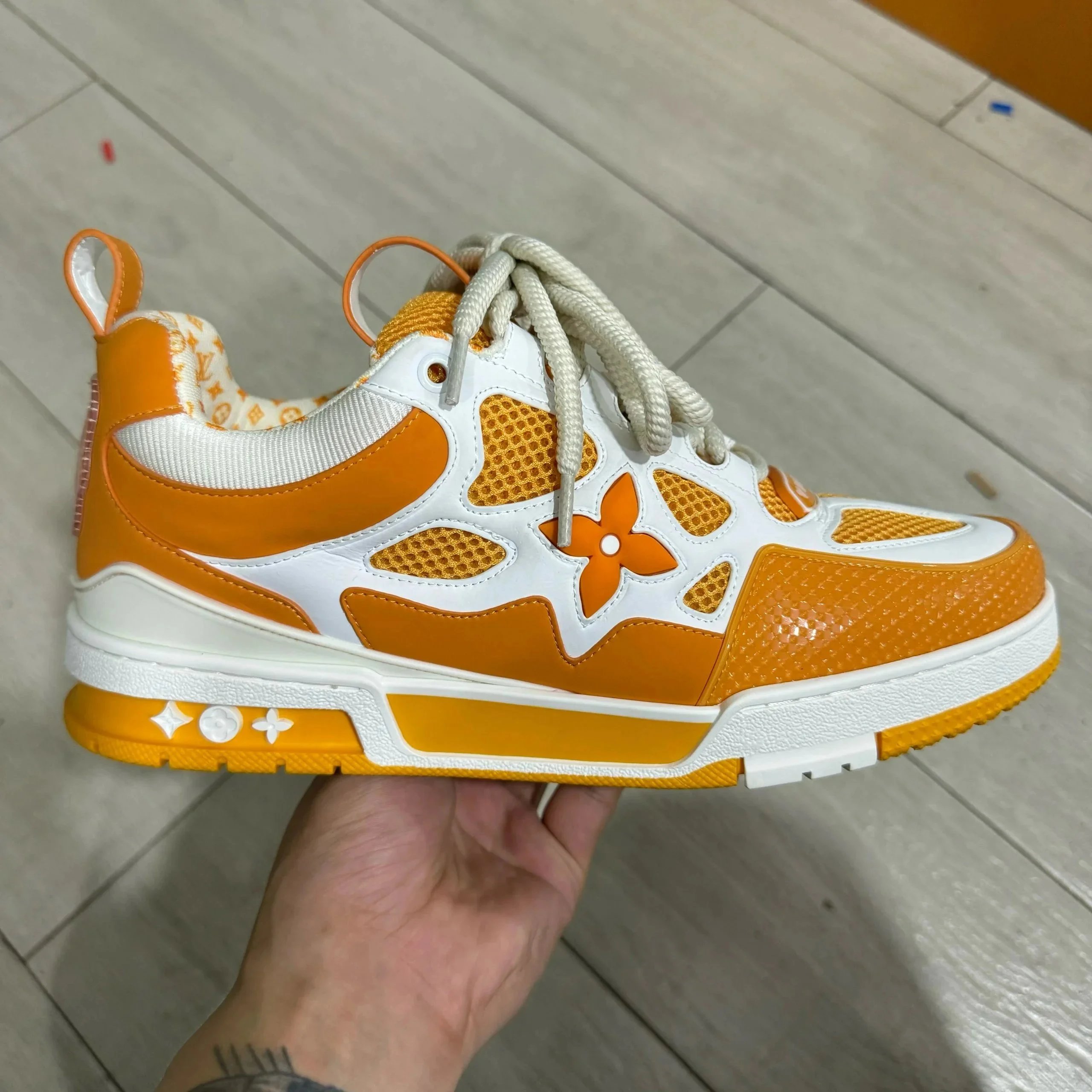 LV ice skates white orange