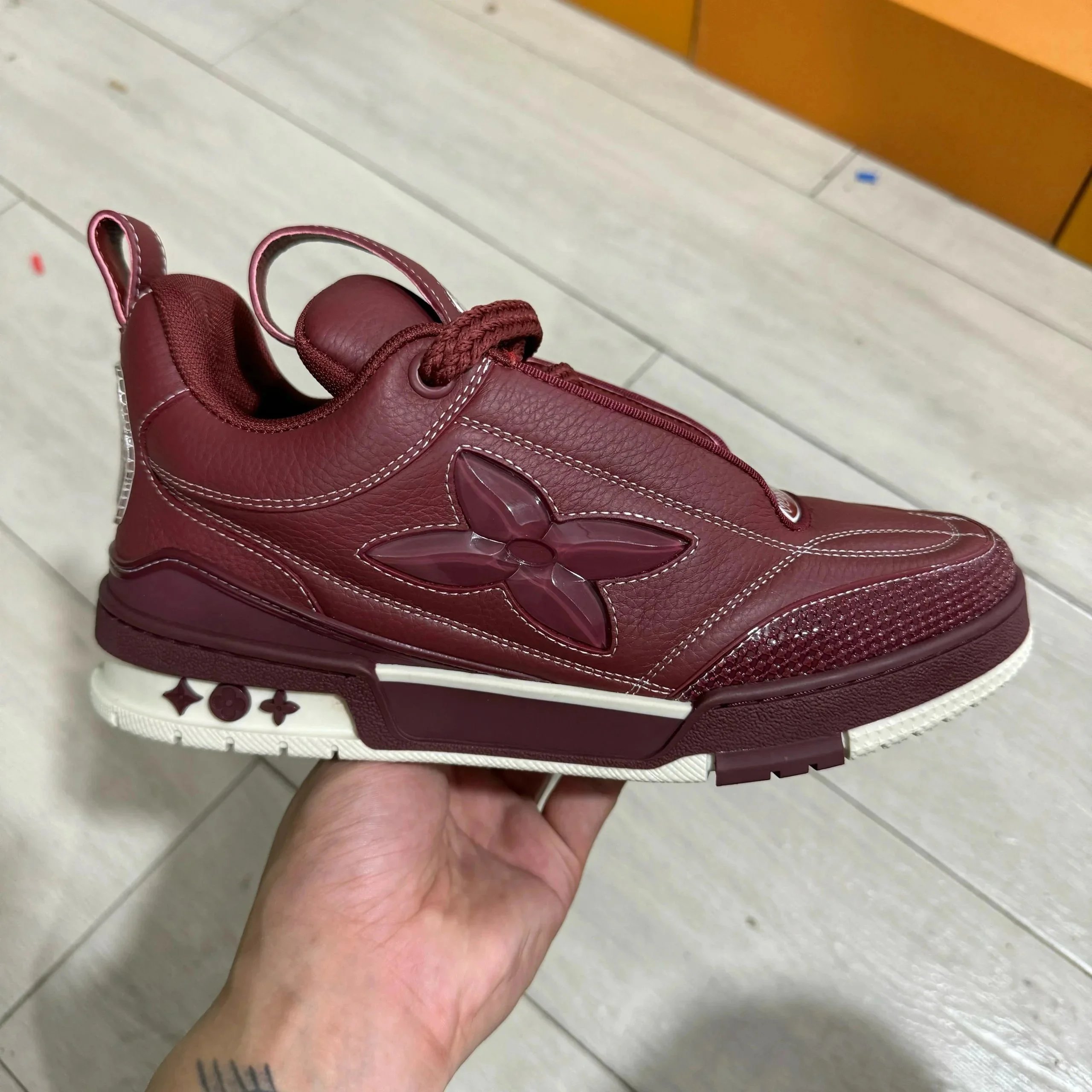 LV ice skates with deep red leather surface