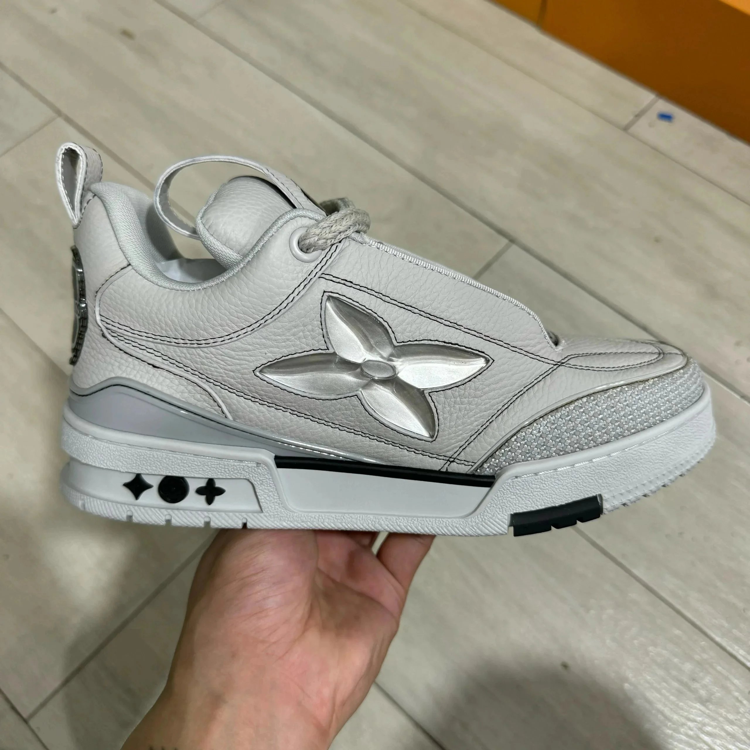 LV ice skates with gray leather surface