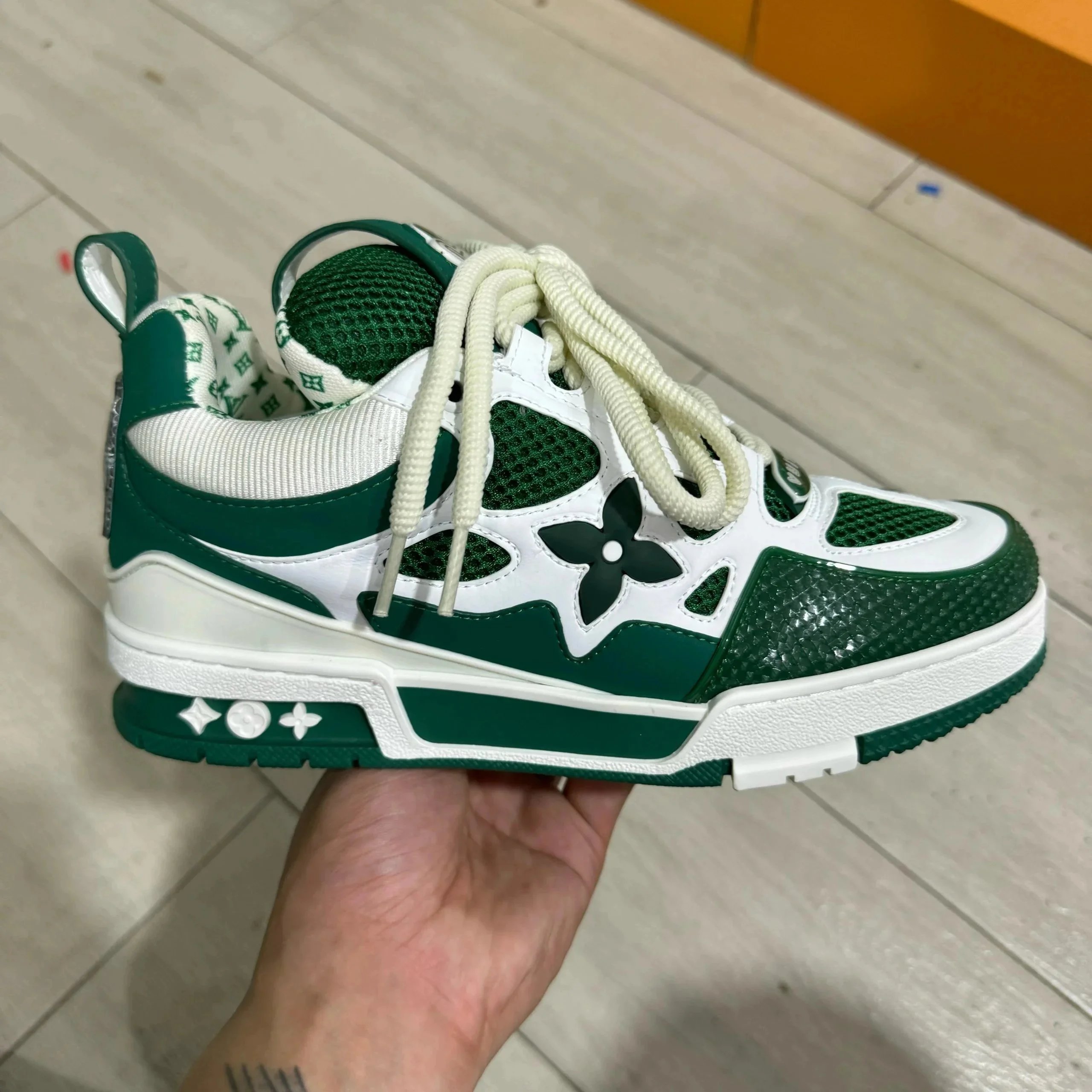 LV ice skates in white and green