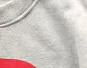 thumbnail for The front stands with a big red heart and a light gray sweatshirt 11101684