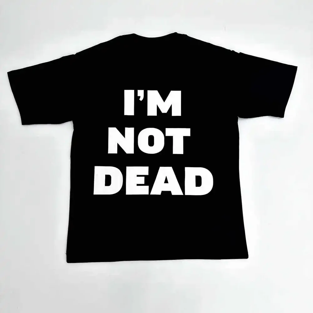 A black T-shirt emblazoned with the slogan "I’M NOT DEAD" has become a popular staple in the Dark High Street / Opium aesthetic in recent years.