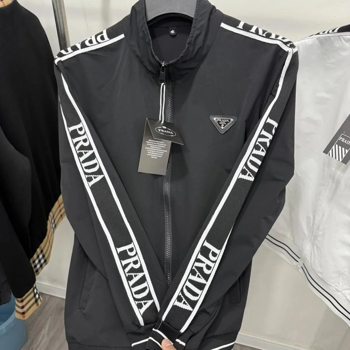 Prada Tracksuits Black zip-up hooded tracksuit with triangle logo patches — Prada21