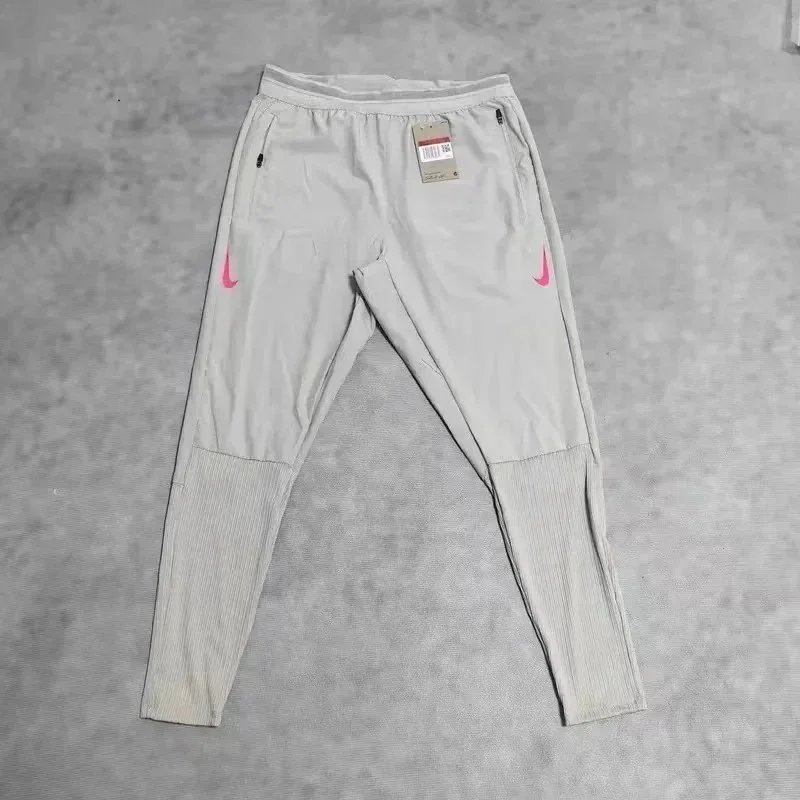 Nike Trousers Tapered running with zip pockets and reflective details — 18