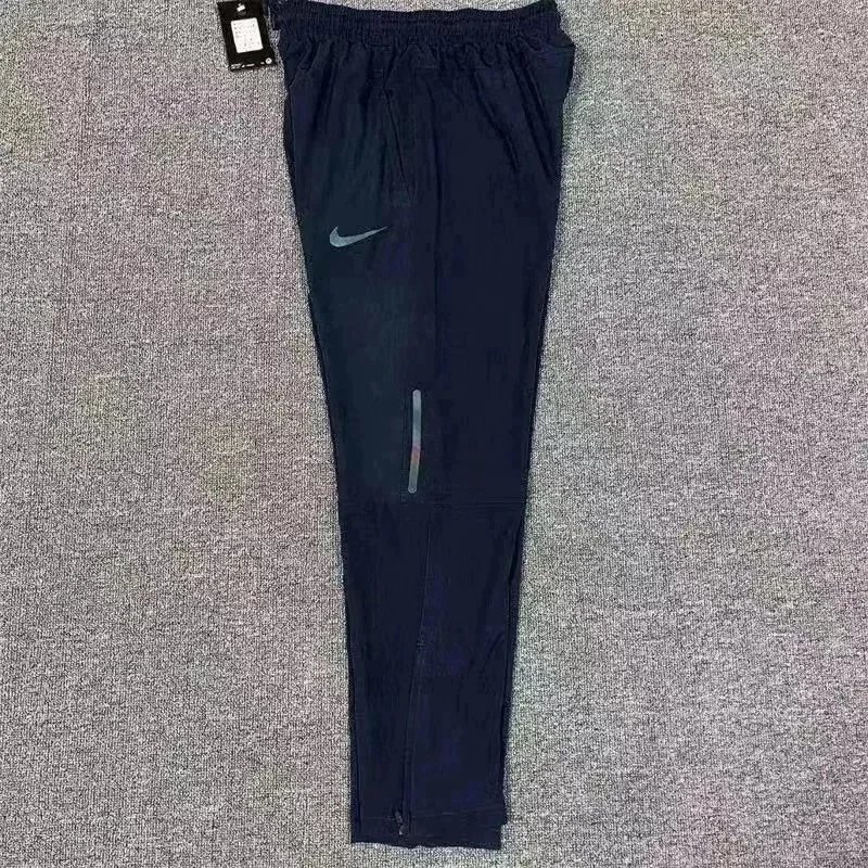 Nike Trousers Tapered running with zip pockets and reflective details — 10 Royal blue