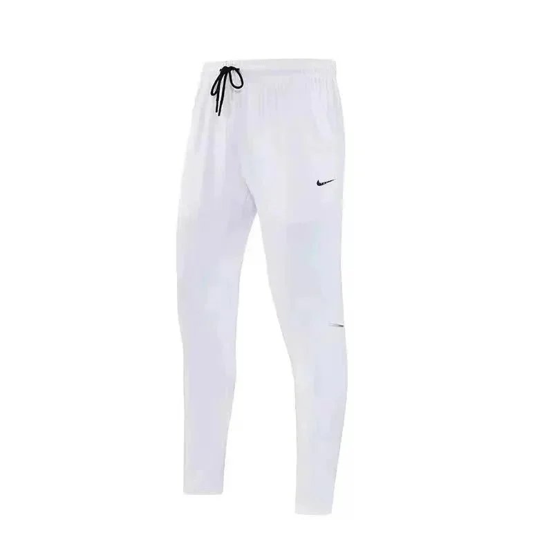 Nike Trousers Tapered running with zip pockets and reflective details — 17