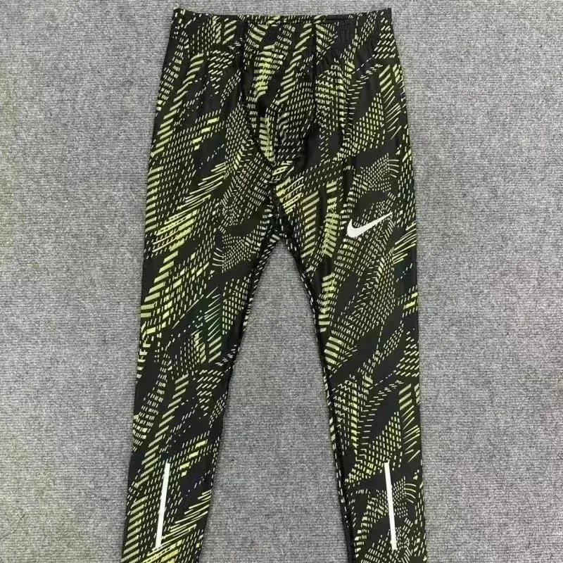 Nike Trousers Tapered running with zip pockets and reflective details — 31