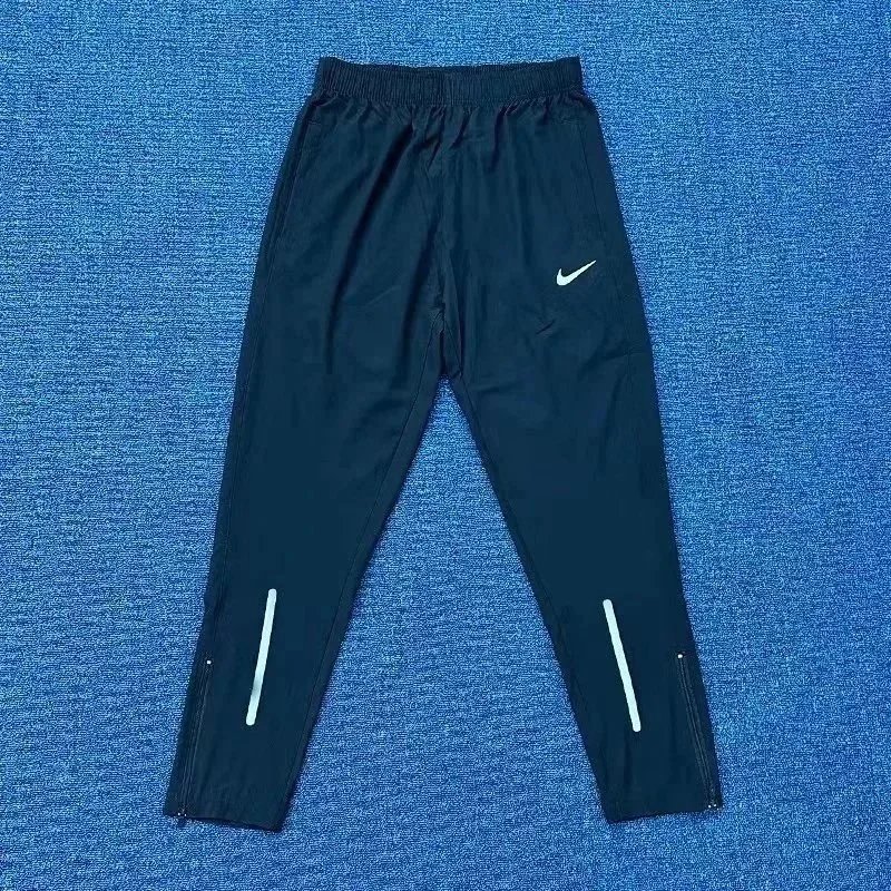 Nike Trousers Tapered running with zip pockets and reflective details — 32