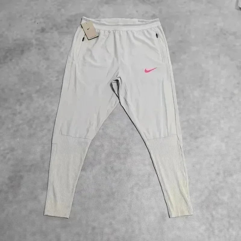 Nike Trousers Tapered running with zip pockets and reflective details — 26
