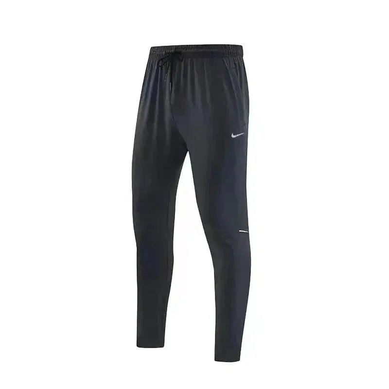 Nike Trousers Tapered running with zip pockets and reflective details — 23