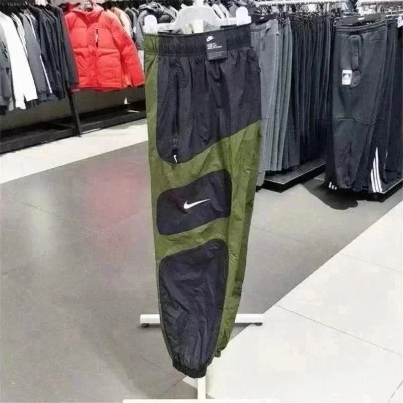 Nike Trousers Tapered running with zip pockets and reflective details — 40
