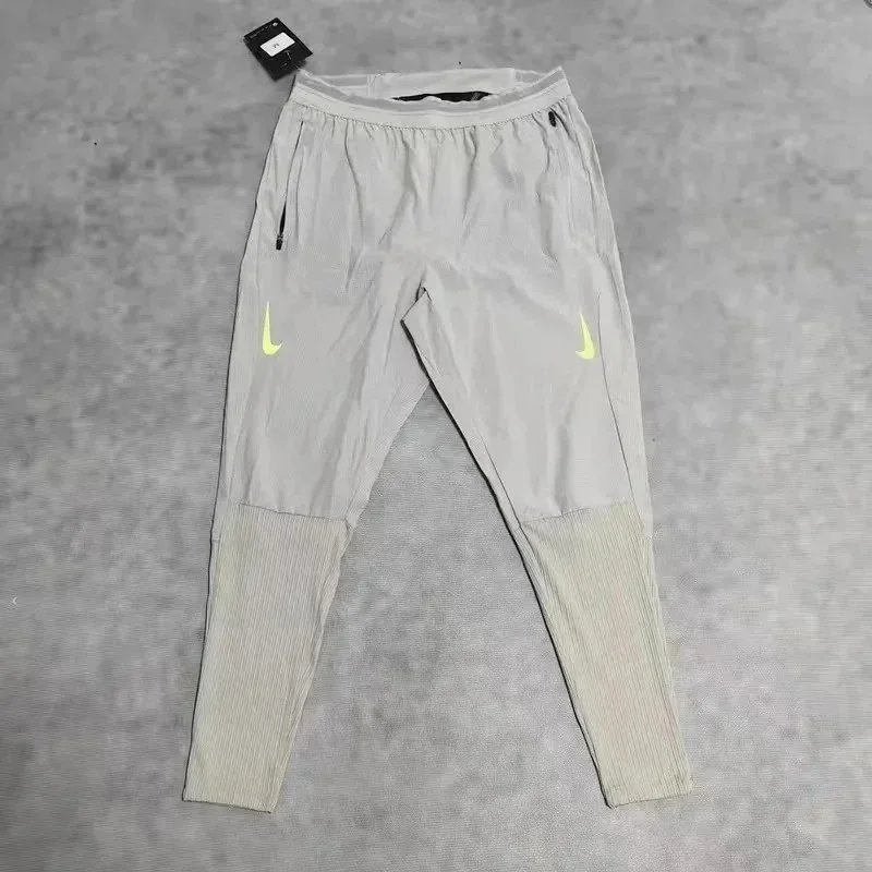 Nike Trousers Tapered running with zip pockets and reflective details — 33
