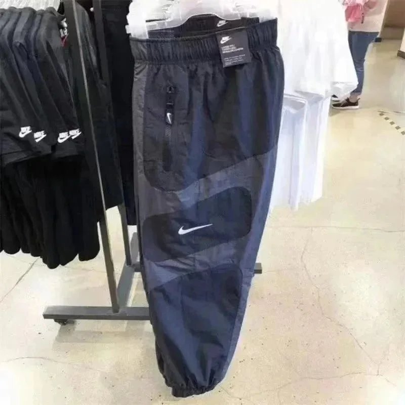 Nike Trousers Tapered running with zip pockets and reflective details — 34