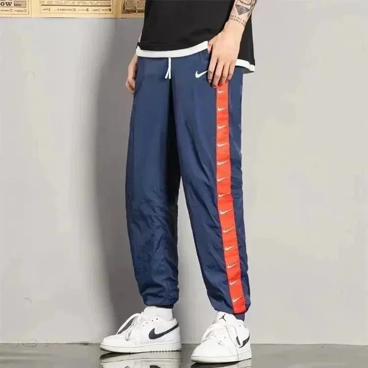 Nike Trousers Tapered running with zip pockets and reflective details — 27