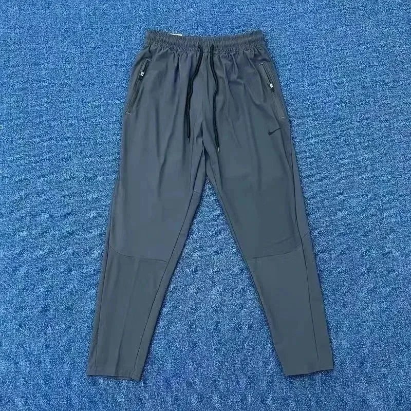 Nike Trousers Tapered running with zip pockets and reflective details — 11
