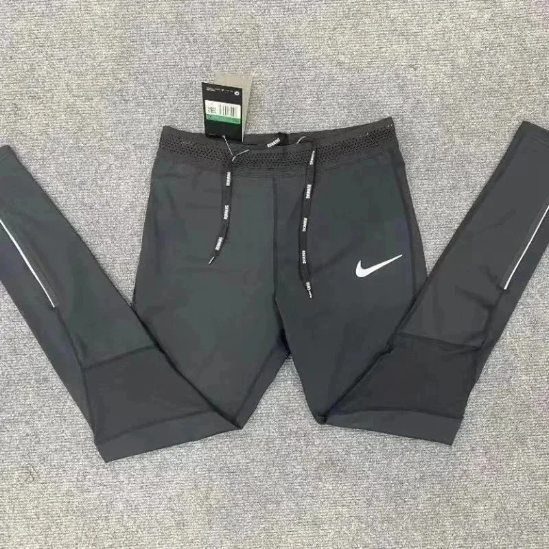Nike Trousers Tapered running with zip pockets and reflective details — 16
