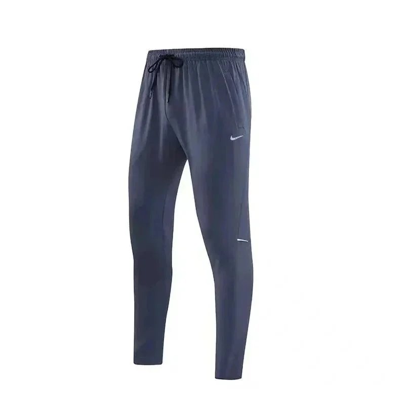 Nike Trousers Tapered running with zip pockets and reflective details — 13