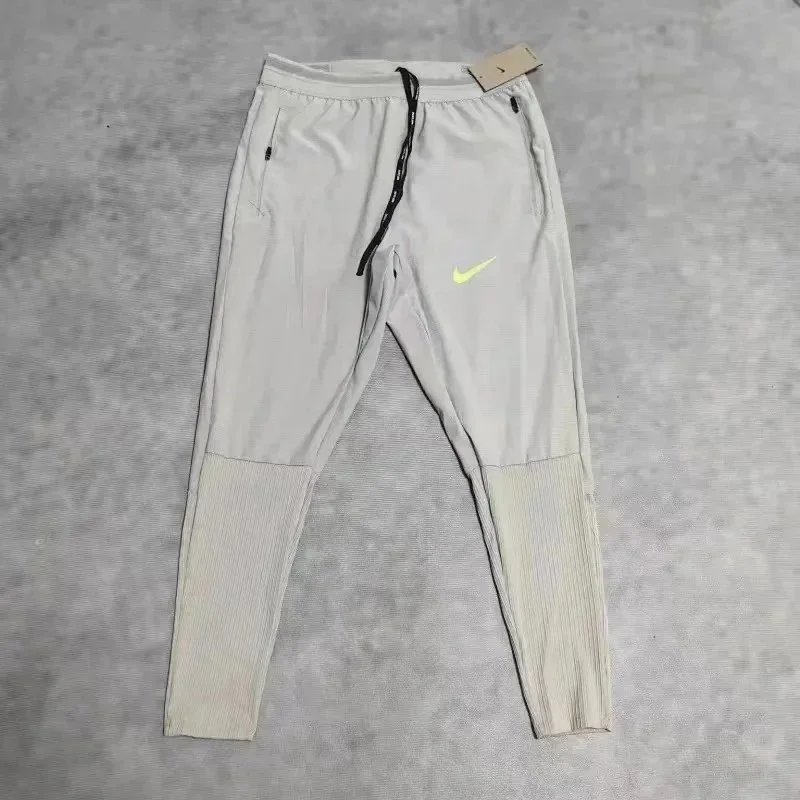 Nike Trousers Tapered running with zip pockets and reflective details — 38