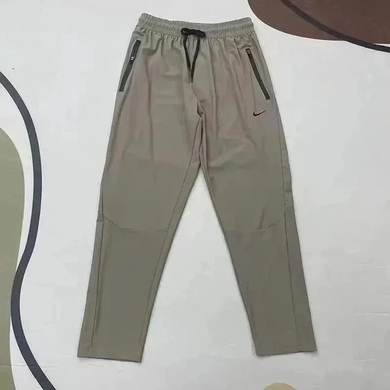Nike Trousers Tapered running with zip pockets and reflective details — 29