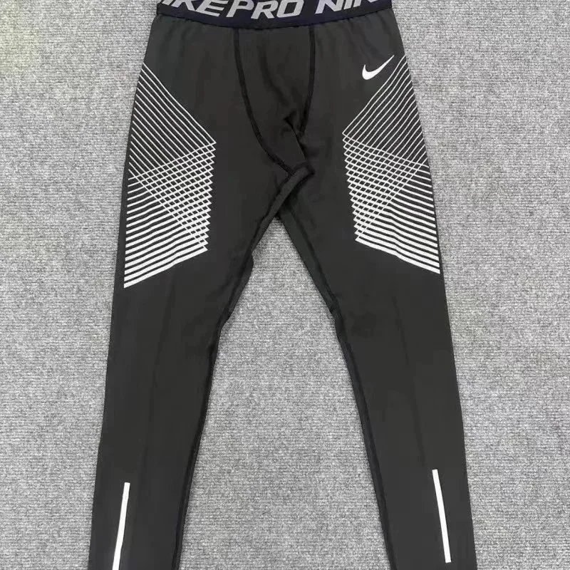 Nike Trousers Tapered running with zip pockets and reflective details — 30