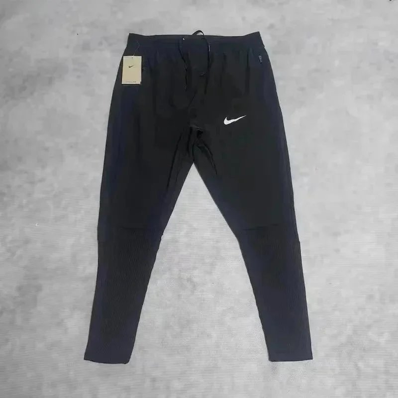 Nike Trousers Tapered running with zip pockets and reflective details — 37