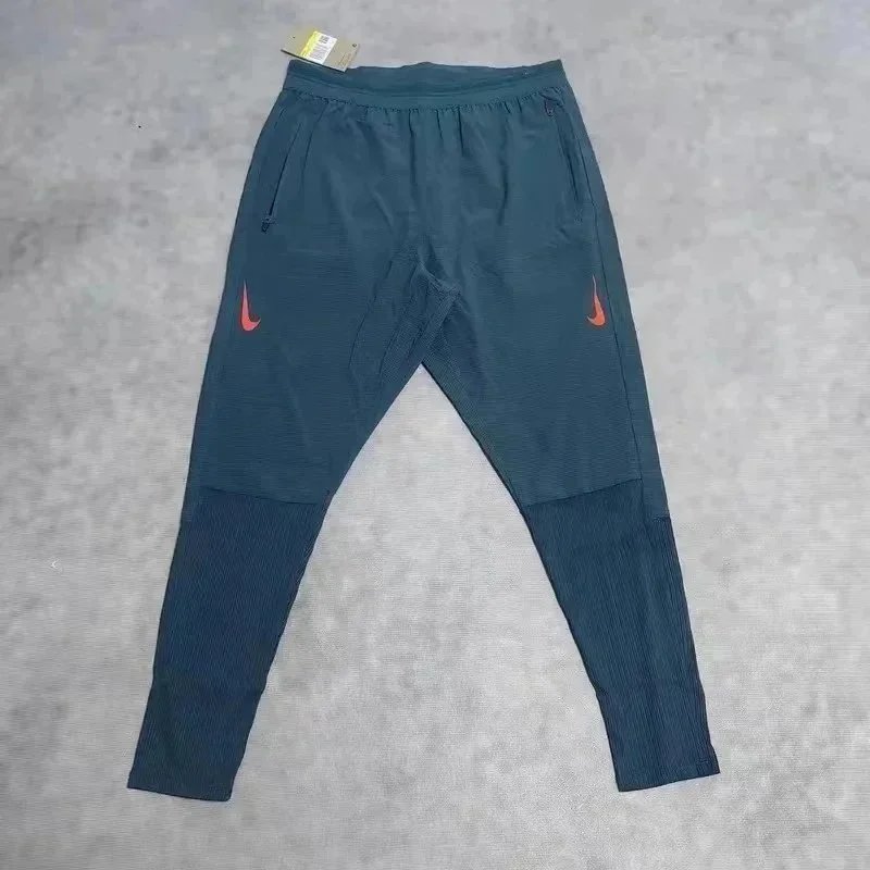 Nike Trousers Tapered running with zip pockets and reflective details — 22