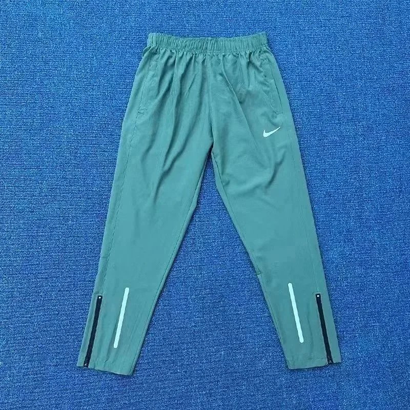 Nike Trousers Tapered running with zip pockets and reflective details — 1