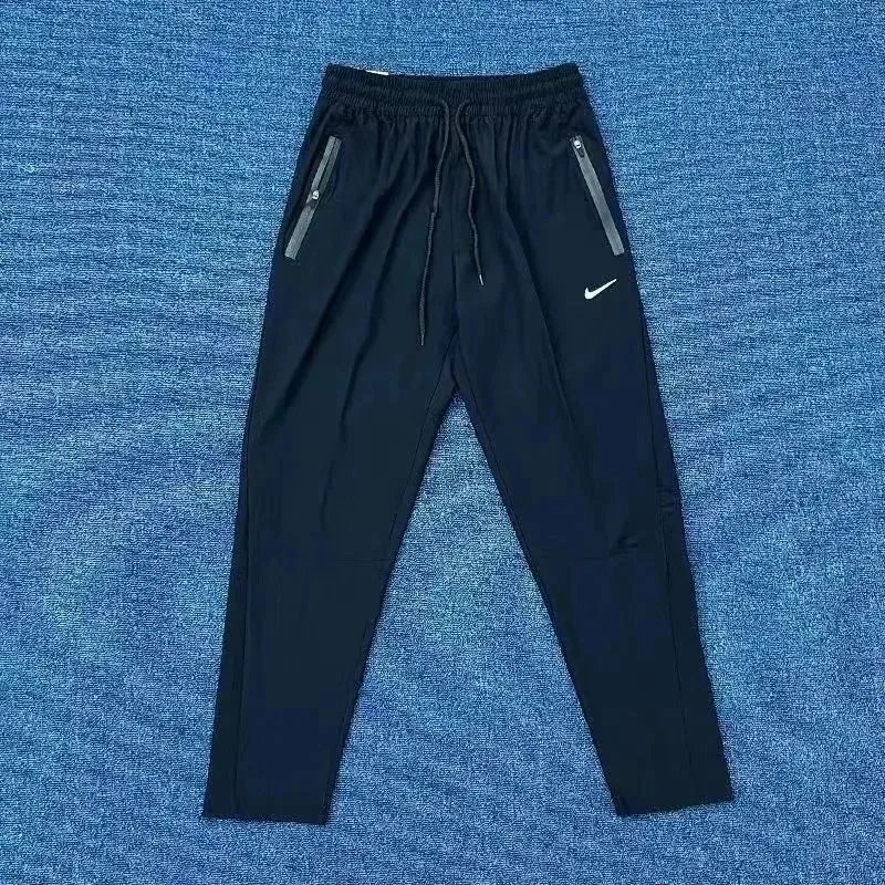 Nike Trousers Tapered running with zip pockets and reflective details — 25