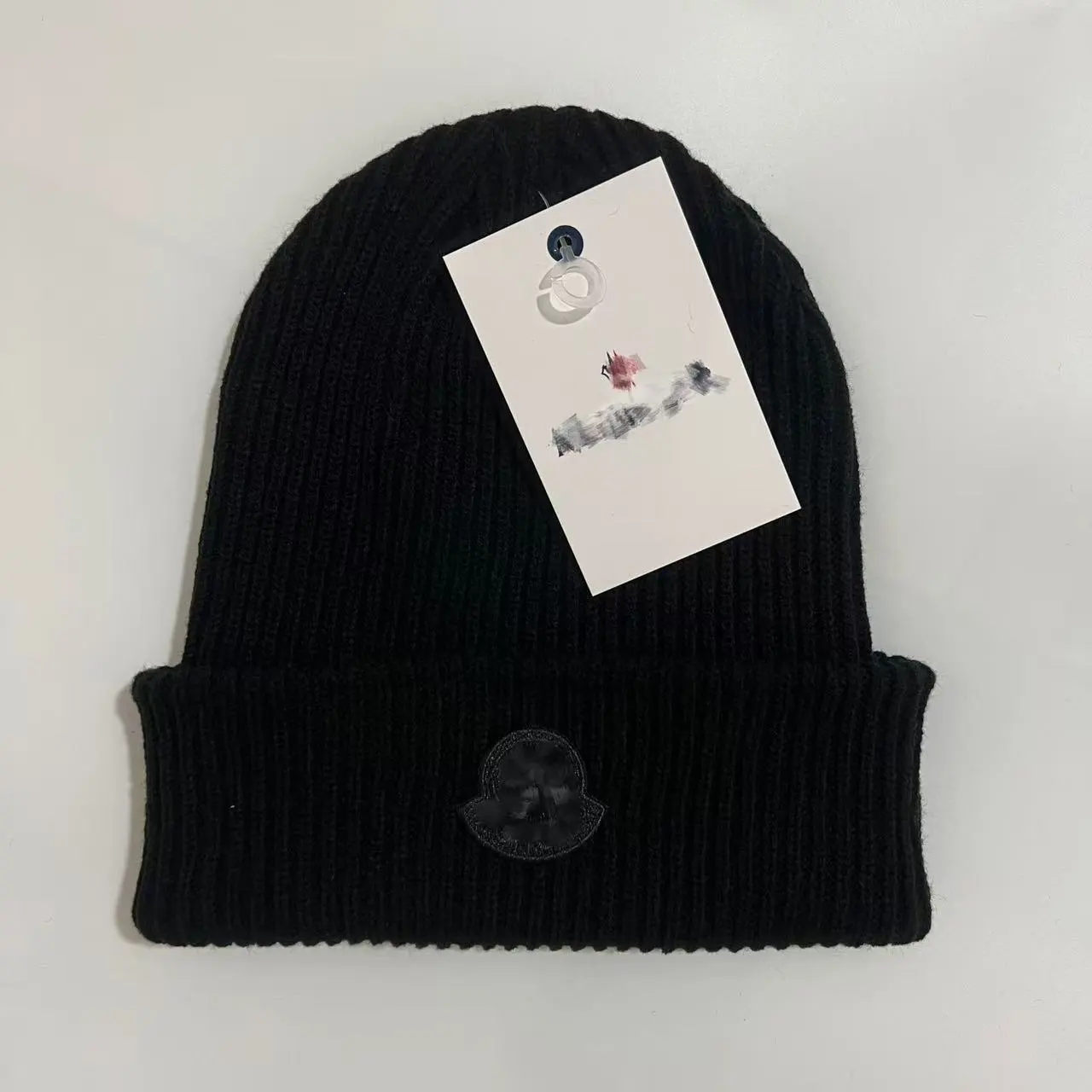 A knitted beanie inspired by Moncler's classic styles.
