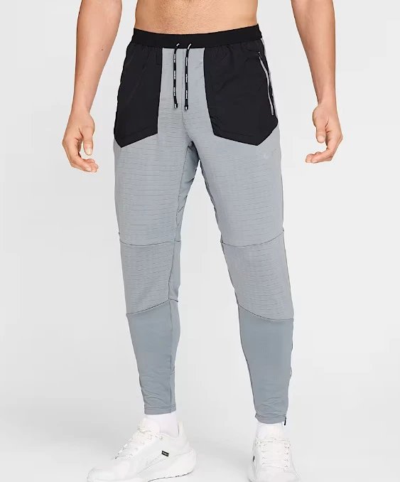 Nike Trousers Slim-fit jogger with zip pockets and ankle zips — Light gray