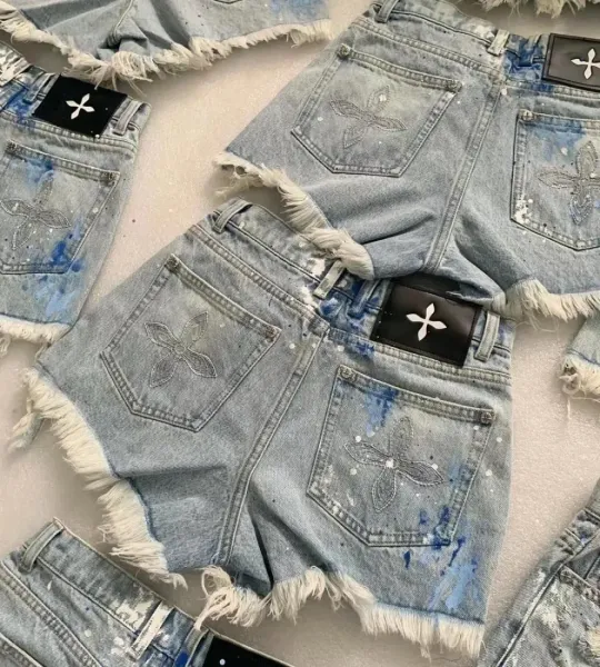 Design Embroidered Fleur-de-Lis Denim Shorts with Frayed Hem and Paint Splatter Detail - 4