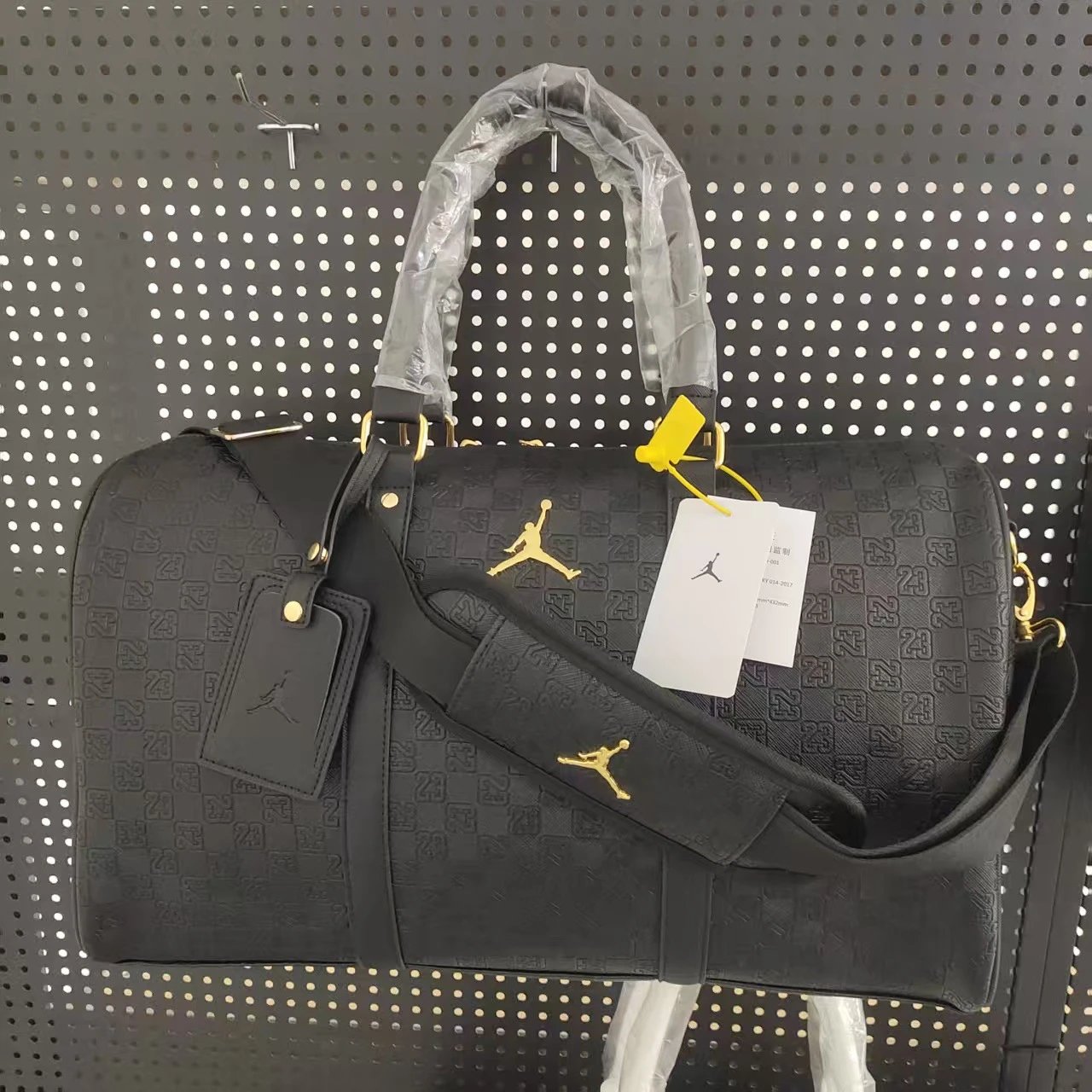 Black and Gold Leather Travel Bag with Studded Bottom