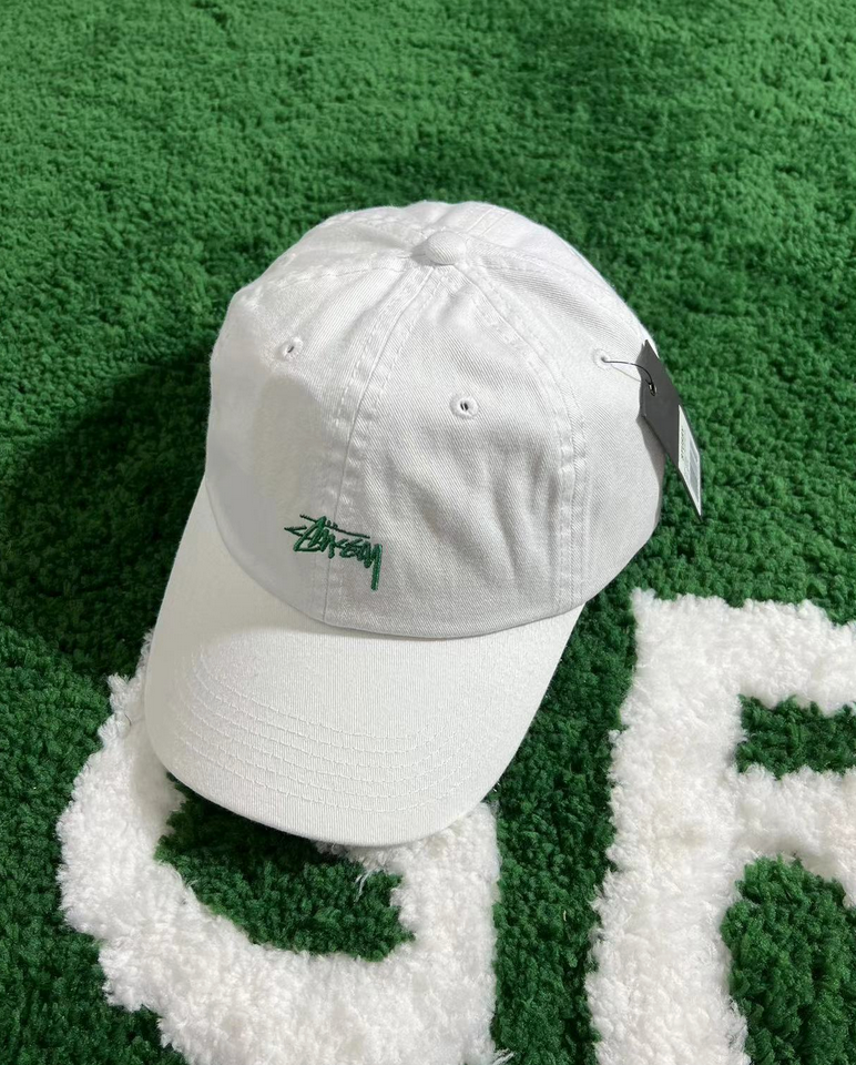 White hat with green letters