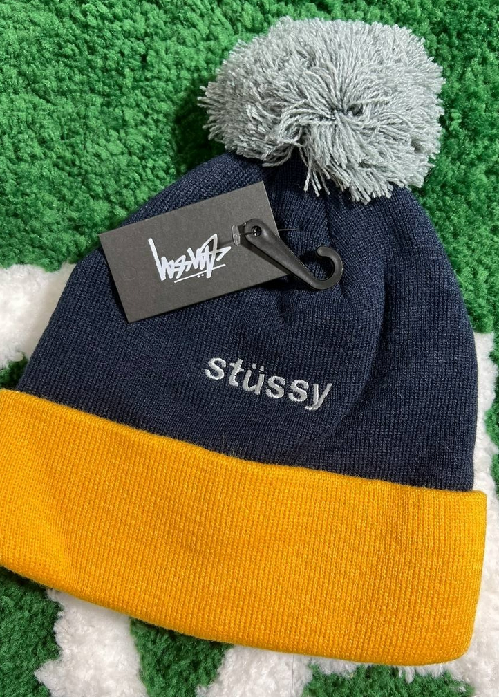 A cold hat with a ball on the head, hidden in blue and yellow