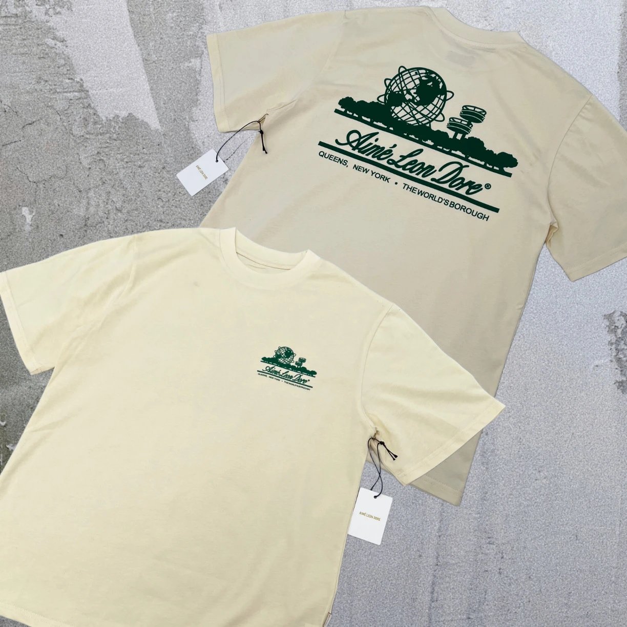 Aimé Leon Dore T-Shirts Short-sleeve logo graphic T-shirt — Beige with a landmark on the back A01