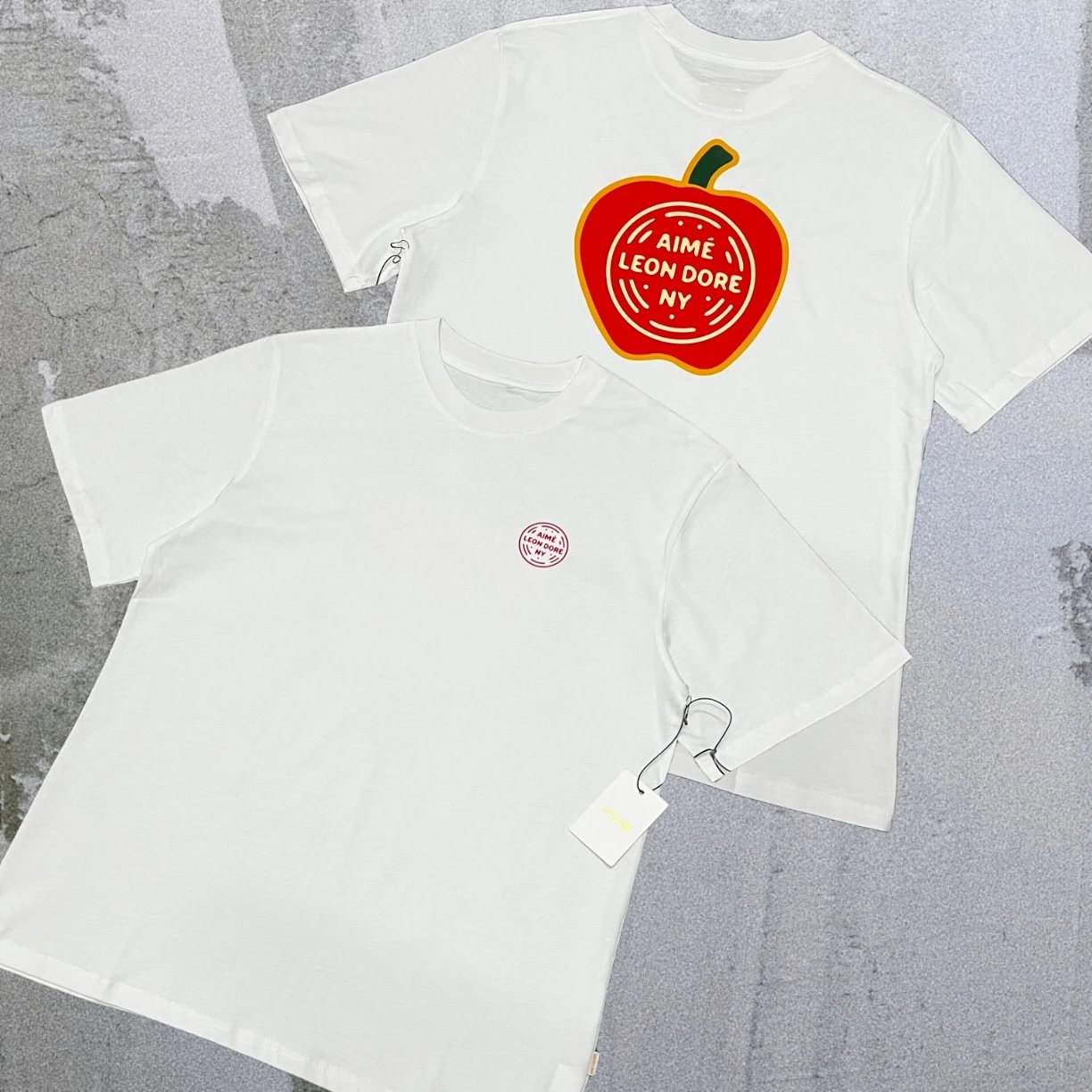Aimé Leon Dore T-Shirts Short-sleeve logo graphic T-shirt — White letter Apple A19