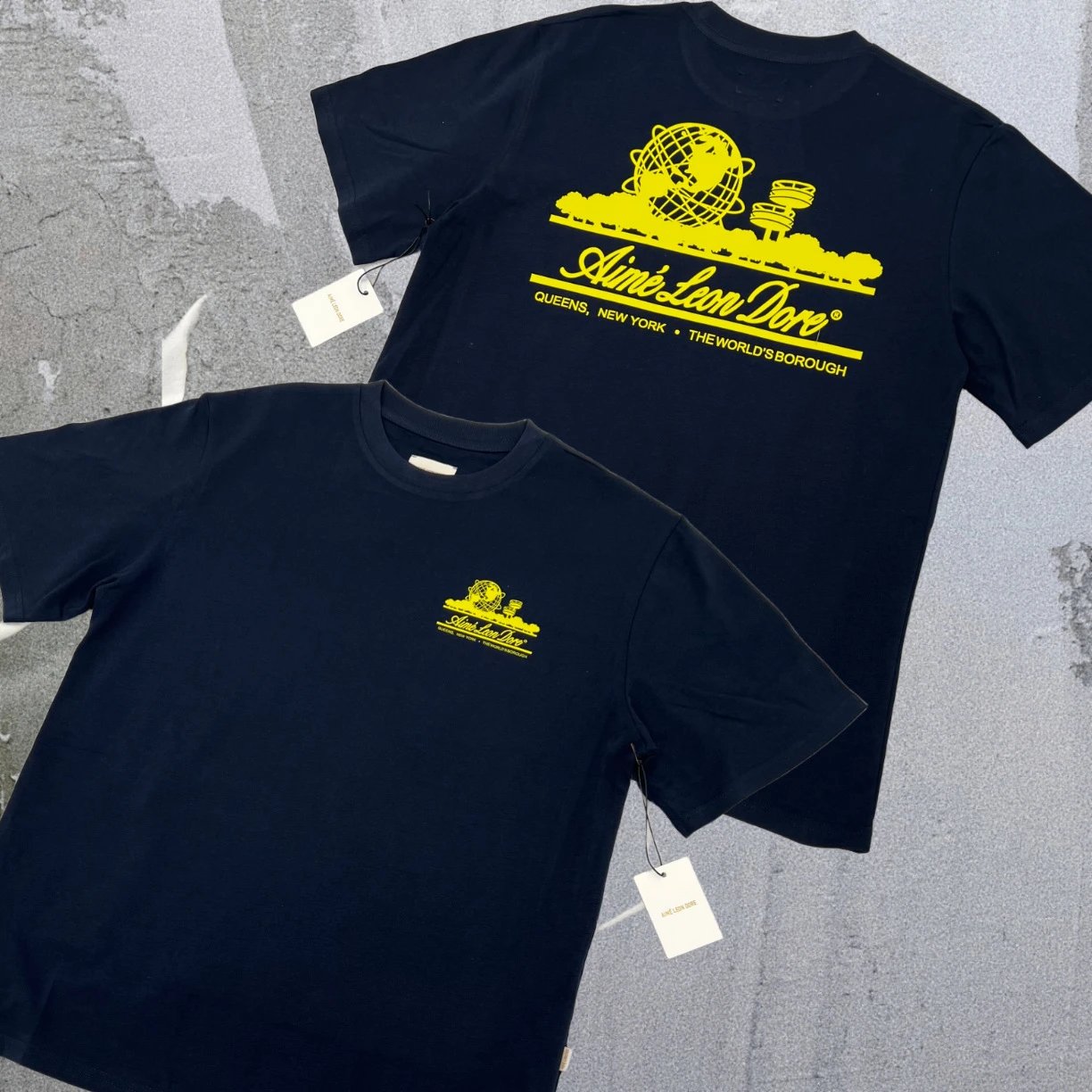Aimé Leon Dore T-Shirts Short-sleeve logo graphic T-shirt — A01 landmark behind the sapphire blue