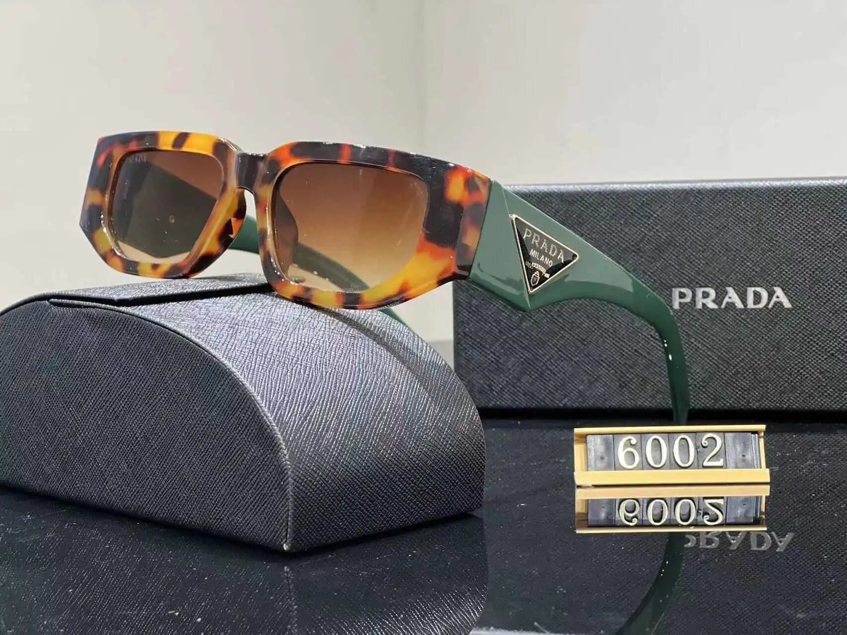 Prada Eyewear Assorted geometric-frame sunglasses with triangle logo plaques — 39